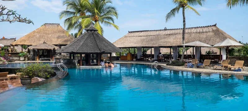 A resort pool surrounded by palms
